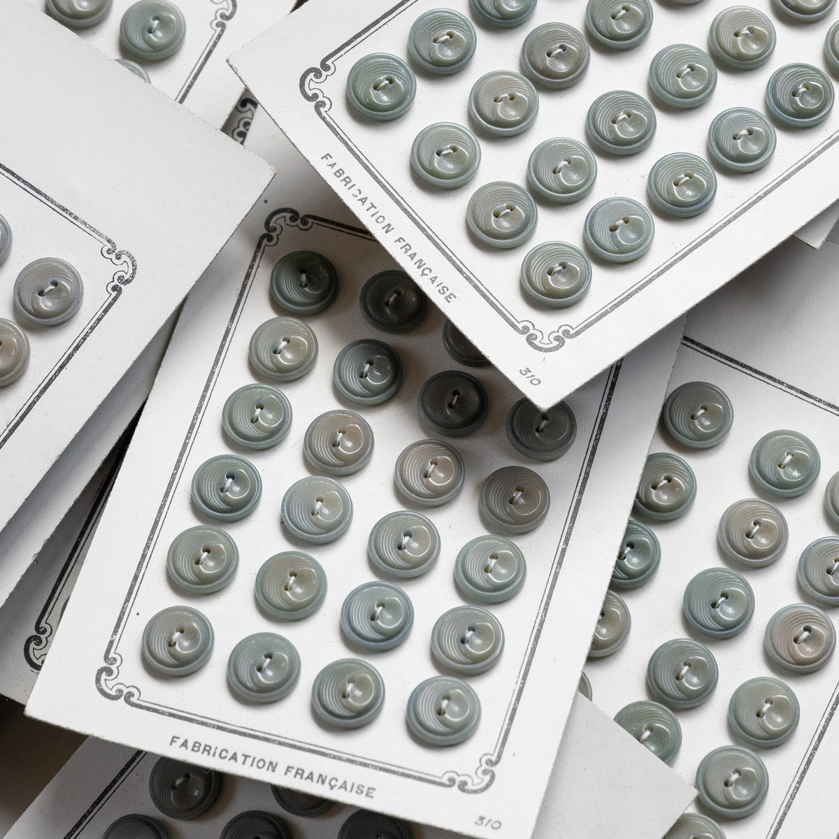 Deadstock nut buttons on FABRICATION FRANÇAISE paper cards.
