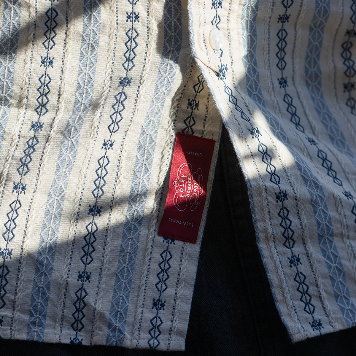 PREQUEL S1023 Classic Stripe Work Shirt (Beige), close-up of the sewn label and surrounding fabric.