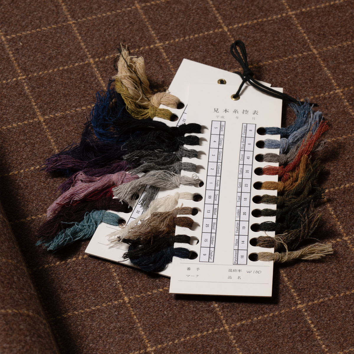 Brown windowpane wool fabric and yarn samples supplied with PREQUEL J1018.