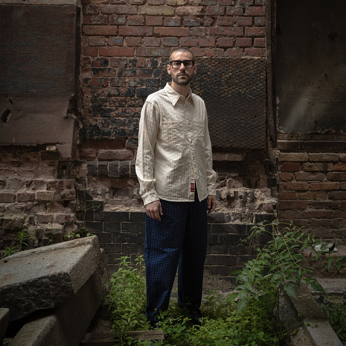 Full-length styling view of PREQUEL P1006 indigo patterned trousers.